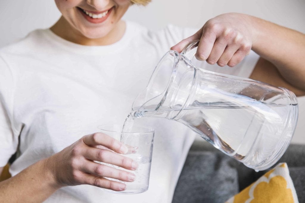 Ilustrasi Wanita sedang menuangkan air ke dalam gelas